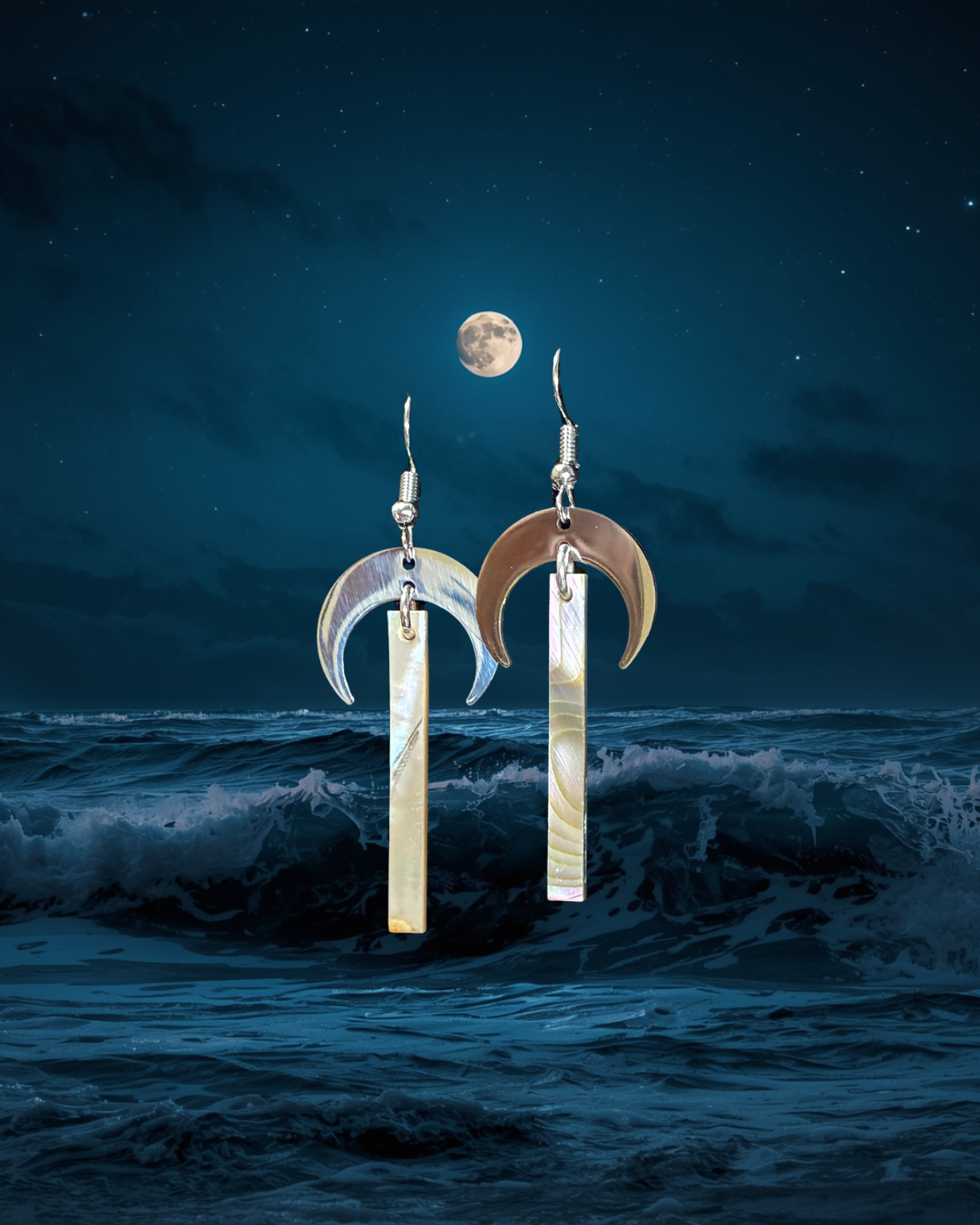 Crescent moon earrings with a moonlit ocean background