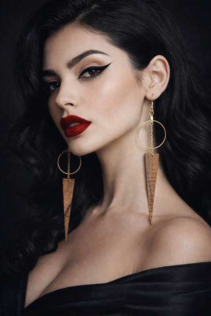 Woman femme fatale wearing gold hoop earrings with wild grain exotic guitar wood spears with a dark background