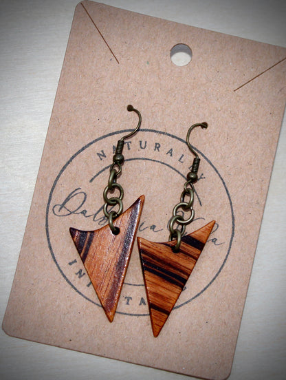 Orange and black striped exotic guitar wood earrings with bronze hardware agains Dalbergia Vida earring display card.