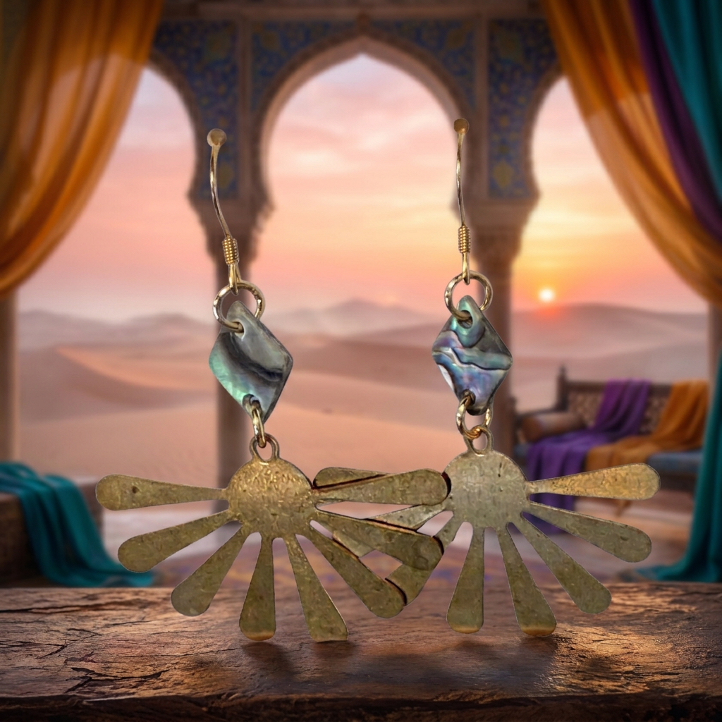 A pair of bohemian-style dangle earrings featuring textured gold-toned metal sunburst shapes and iridescent abalone shell accents, shown against a plain white background.