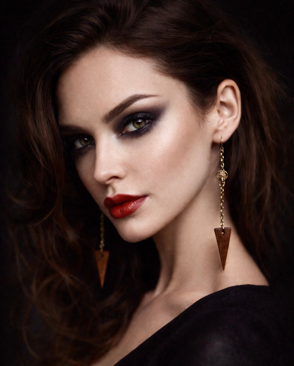 dark elegant woman wearing tangled chain earrings with wooden spikes from Martin guitar factory.