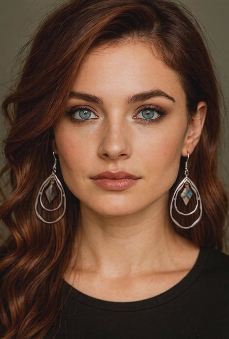 Red hair woman wearing elegant silver double hoops earrings with abalone pearl diamonds in center. Martin guitar sourced pearl inlay.